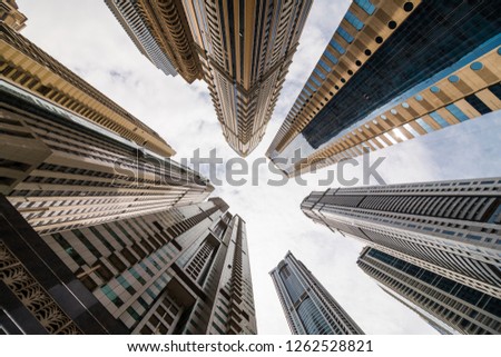 Dramatic perspective with low angle view of skyscrapers looking up to the sky, Dubai. Vanishing point