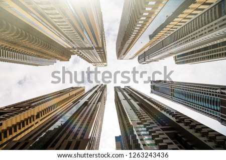 Dramatic perspective with low angle view of skyscrapers looking up to the sky, Dubai. Vanishing point