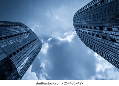 Dramatic Perspective of Modern Skyscrapers Reaching into the Cloudy Sky