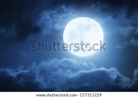 Dramatic photo illustration of a nighttime sky with brightly lit clouds and large, bright full moon would make a great background.