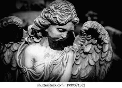 Dramatic Photo Of Sad Angel With Deep Shadows. Fragment Of Ancient Statue. Death And Pain Concept. Horizontal Image.