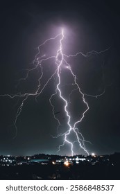 A dramatic photograph capturing powerful lightning strikes illuminating the dark sky. The jagged bolts of electricity contrast against the storm clouds, creating a breathtaking natural spectacle.