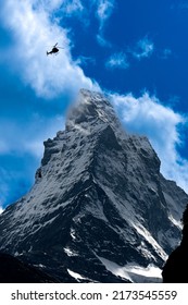 A Dramatic Picture Of Matterhorn With Cloud And Motion Blur Helicopter Passing By Insight.