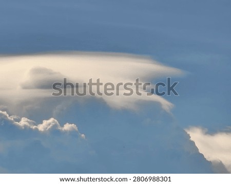 Dramatic Pileus Cloud Formation Casting a Shadow Over a Cumulus Tower