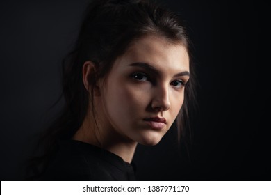 Dramatic Portrait Of A Beautiful Girl On A Dark Background