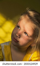 Dramatic portrait of beautiful little child girl with shadow on face. lonely in dark. unknown and extraordinary child's soul and inner world