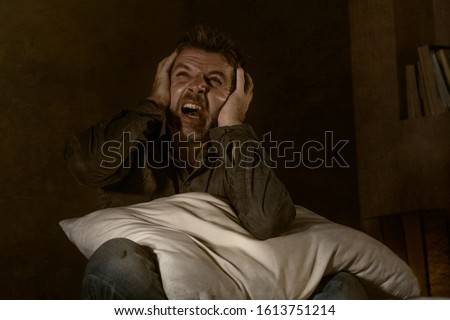 dramatic portrait of depressed and sick man suffering from psychosis illness or mental disorder looking weird and helpless in psychiatric and psychological problem concept