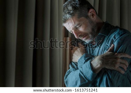 dramatic portrait of depressed and sick man suffering from psychosis illness or mental disorder looking weird and helpless in psychiatric and psychological problem concept