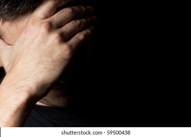 Dramatic Portrait Of A Sad, Desperate Unrecognizable Man In Pain Hiding His Face