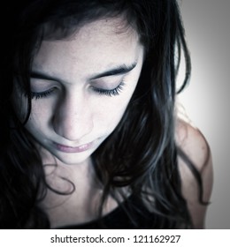 Dramatic Portrait Of A Sad Hispanic Girl Photographed From Above With A Shallow Depth Of Field