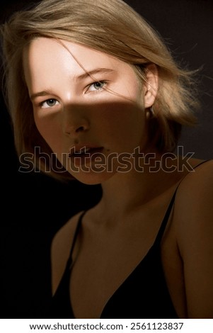 Similar – Image, Stock Photo Dramatic portrait of Black adult man looking up into spotlight while standing on stage in theater with low light copy space