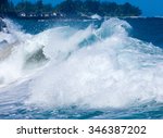 Dramatic powerful waves crash onto sand on dangerous beach at Lumaha
