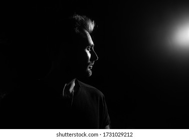 Dramatic Profile Portrait Of Male Person On Dark Background