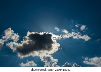 Dramatic Puffy White Clouds In The Blue Sky, Sun Cover Behind The Clouds, Summed Day, No People..