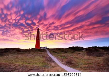 dramatic purple mammatus clouds over lighthouse, Schiermonnikoog