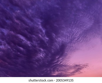 Dramatic purple sky at night background. Impressive cloudscape in evening heaven. Beautiful fantastic thunderous skies. 