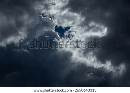Dramatic rain clouds with sun rays, abstract weather backdrop