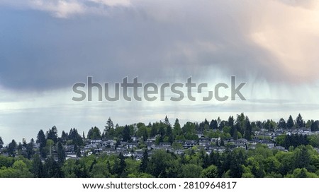 Dramatic Rain Shower Cloud Over Green Suburban Neighborhood Hillside