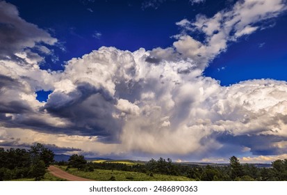 Dramatic rain storm clouds over the sunlit Wet hills