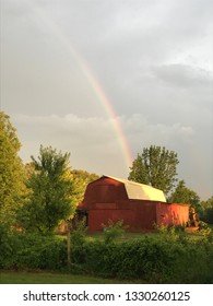 Dramatic Rainbow over Red Barn in the Country