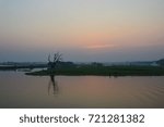 dramatic red and black clouds in sunset over water - vintage effect look