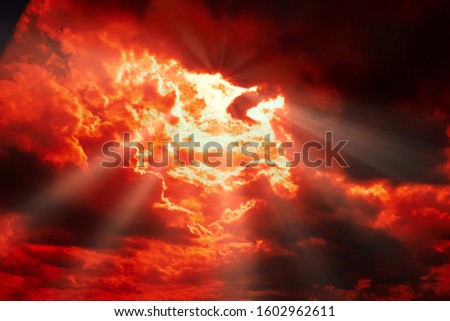 dramatic Red clouds and sunray for pattern background. A burning sky in a horror movie.  crimson storm in apocalyptic, judgment day.