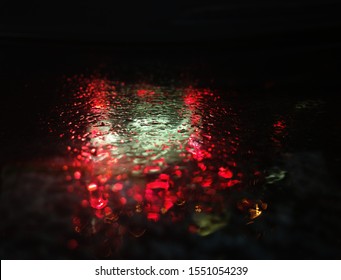 Dramatic red and green raindrops on rainy surface background