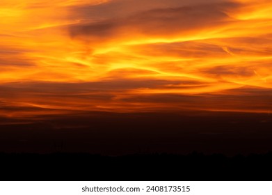 Dramatic red sky as background with dark black ground