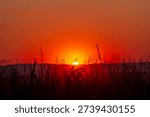 Dramatic red sunset over rural landscape near Macin, Tulcea, Romania