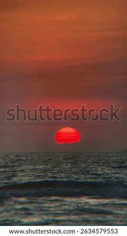 Dramatic red sunset sinking below the horizon over the ocean. Evokes feelings of mystery and the end of the day. Ideal for dramatic landscape visuals. #RedSunset #OceanSunset #DramaticSky