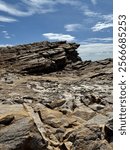 Dramatic Rock Outcrop Against the Sky
“A striking image of a rugged rock outcrop at Khrua Laem Ya, Thailand, with dramatic angles and textured details set against a vibrant blue sky. An evocative capt