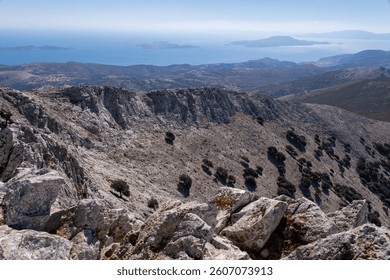 Dramatic rocky landscape at the summit of Mount Zeus, highest peak of the Cyclades, with breathtaking views of surrounding islands and the blue Aegean Sea