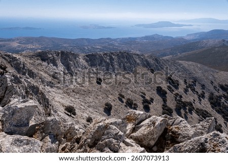 Dramatic rocky landscape at the summit of Mount Zeus, highest peak of the Cyclades, with breathtaking views of surrounding islands and the blue Aegean Sea