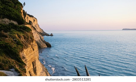 The dramatic sandstone cliffs of Loggas Beach in Peroulades, Corfu, glowing under a magnificent golden sunset, inspiring a powerful sense of ultimate freedom, inner peace, and wanderlust.