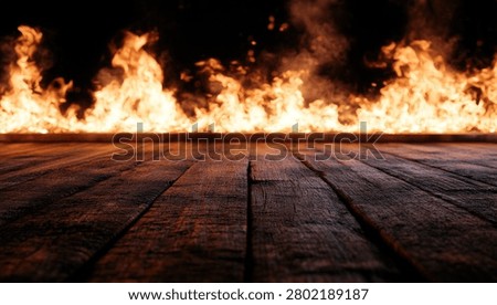 A dramatic scene of intense flames burning across a dark wooden floor, creating a powerful and dangerous atmosphere.