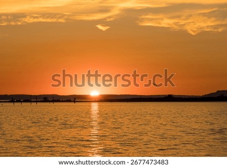Dramatic scene as the sun sets over the islands at sunset off Everett in Possession Sound Washington State