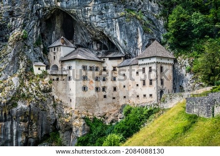 Dramatic scenery of medieval cliff top Predjama castle and caves, Slovenia
