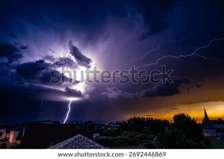Dramatic scenery of stormy sky with lightning at sunset