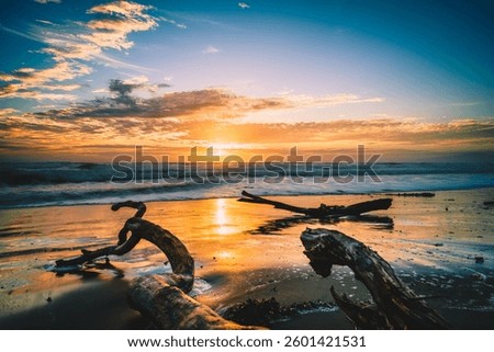 A dramatic scenery of a sunset on the beach in Christchurch, New Zealand in cloudy sky background