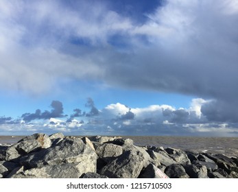 Dramatic scenic view of clouds, sea and rocks