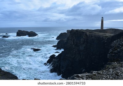 Dramatic Scottish Lighthouse on Rugged Coastline with Cloudy Oce