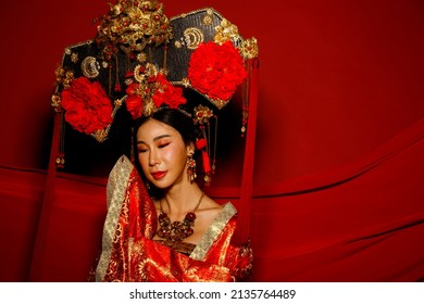 Dramatic Series Female Express Feeling Emotional With Fabric Fluttering In The Air. Asian Woman Wear China Royal Empress Traditional Costume With Golden Line Design Dress And Headwear, Red Background