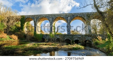 Dramatic seven-arch limestone Durrow Viaduct, historic railway landmark, Waterford Greenway, autumn, no people
