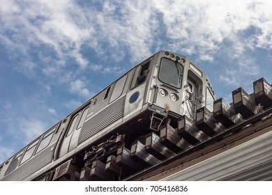 Dramatic Shot Of Chicago El Subway Passing Overhead With Blue Skies On Old Wooden Tracks