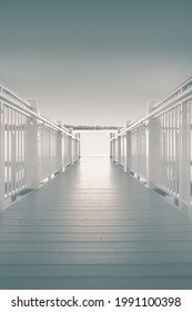 A Dramatic Shot Of White Wooden Jetty Walk Leading To The Sea Under The Clear Sky