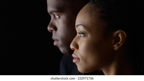 Dramatic Side View Of Two Young African American People On Black Background
