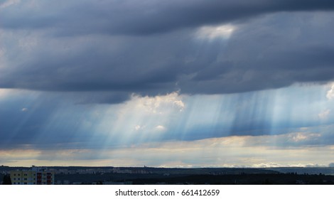 Dramatic sky above the city,sun rays through clouds