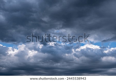 dramatic sky after the storm. Beam of light in gray clouds.