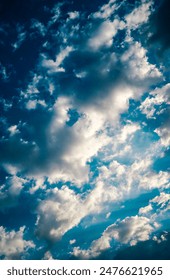 dramatic sky with black stormy clouds before rain or snow as abstract background, extreme weather, the sun shines through the clouds