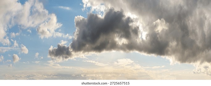 Dramatic sky with blue breaks in heavy clouds over a bright horizon. Cloudscape Background